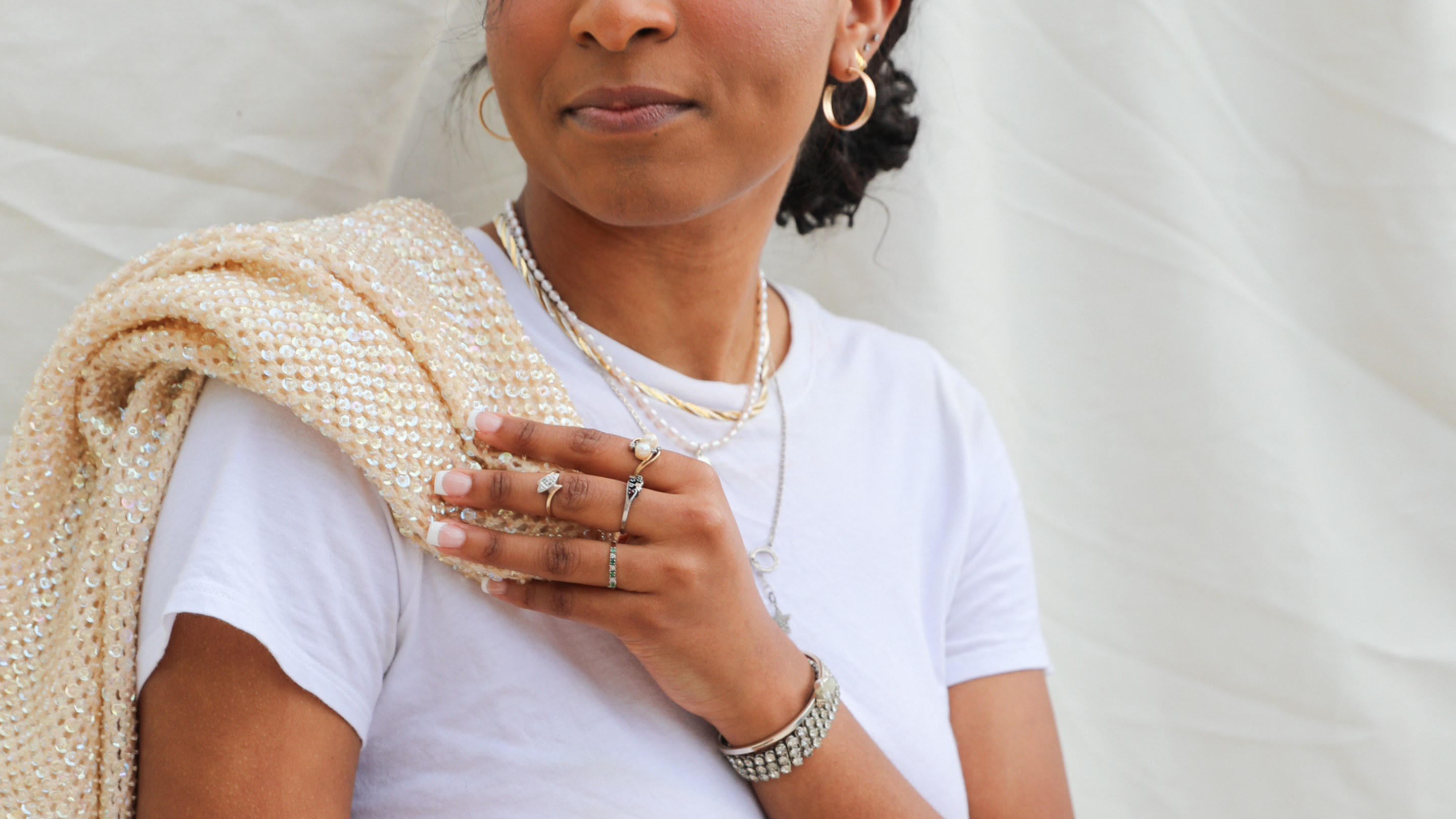 female model with fine jewelry rings, bracelets, necklaces, and earrings