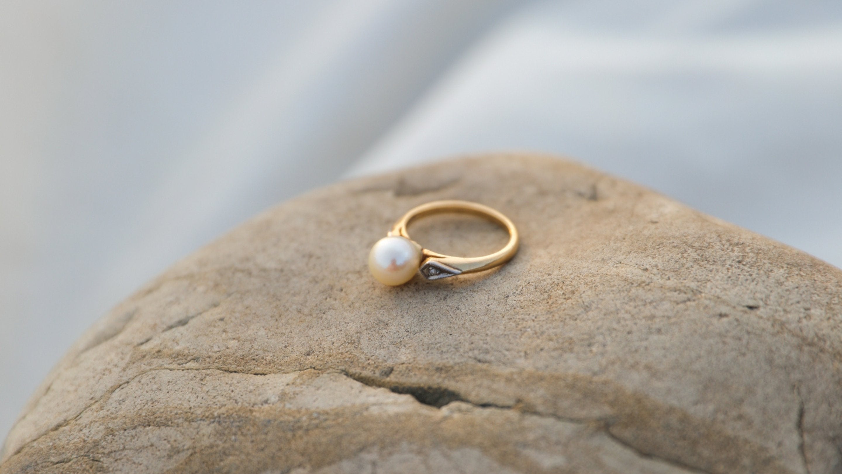 gold pearl ring on rock